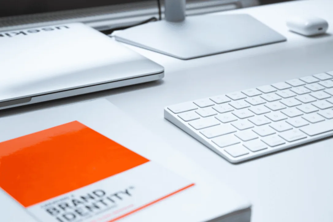 Desk with keyboard and a brand identity book